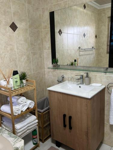 a bathroom with a sink and a mirror at Executive en-Suite - Southgate in Southgate