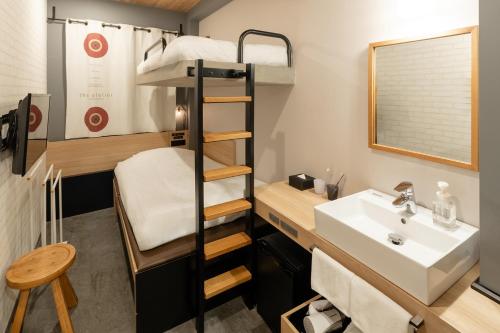 a small bathroom with a bunk bed and a sink at Sakura Terrace The Atelier in Kyoto