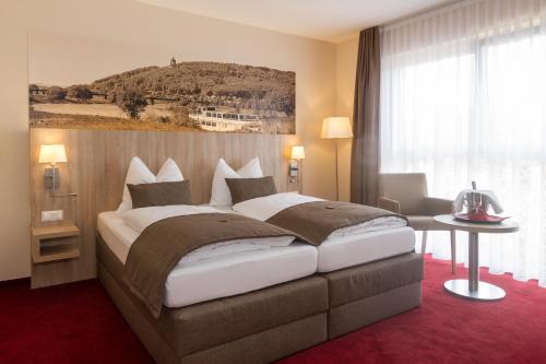 Postel nebo postele na pokoji v ubytování Hotel Weserschiffchen