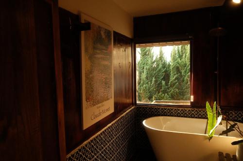 a bath tub in a bathroom with a window at SIA Home - Dalat Haus in Ấp Ða Lợi
