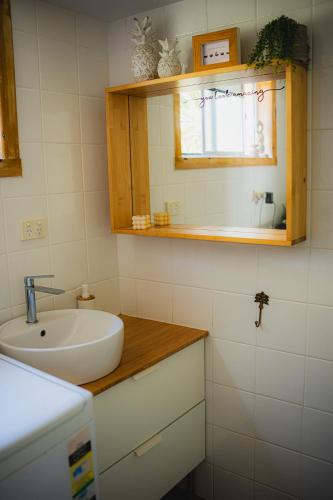 a small bathroom with a sink and a window at Surf Shack in Iconic Rainbow Bay - Coolangatta QLD (pet friendly) in Gold Coast