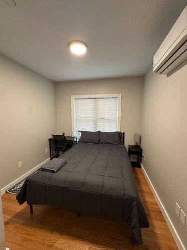 a bedroom with a large bed and a window at HomeStay in Boston West Bellflower Street in Boston