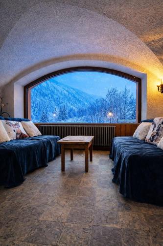 a room with two beds and a large window at Splendid ski-in,ski-out historical chalet! in La Lechere