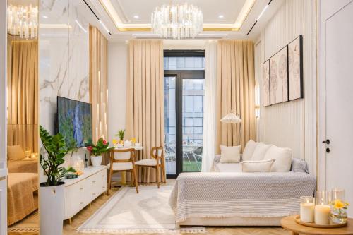 a living room with a bed and a table at NOVA HOME Apartments - NEST ONE, Panoramic Views, Tashkent City in Tashkent