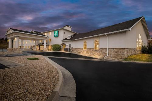 a hotel building with a road in front of it at Quality Inn near Monument Health Rapid City Hospital in Rapid City