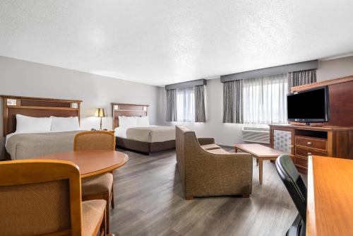 a hotel room with two beds and a flat screen tv at Quality Inn near Monument Health Rapid City Hospital in Rapid City