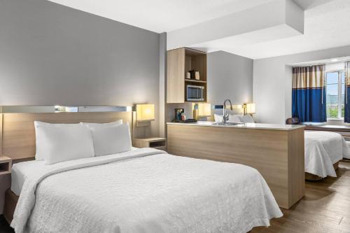 a hotel room with a bed and a sink at Quality Inn & Suites Nashville - Bellevue in Nashville