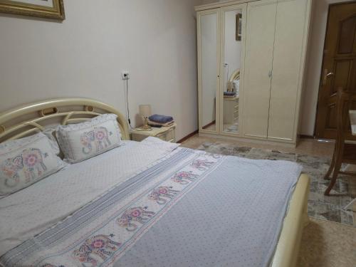 a bedroom with a large bed with pillows at Samia House Room on Furkat 8 in Tashkent