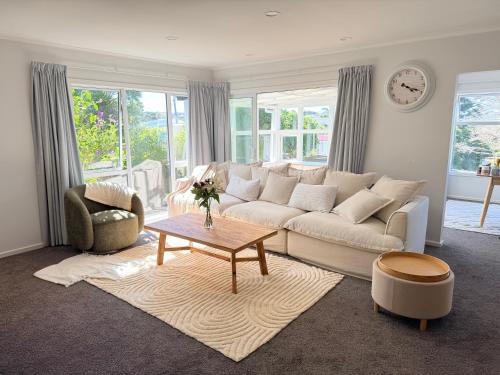 a living room with a white couch and a table at Sunny Spacious Room, Free Parking, Close to Ferry in Wellington