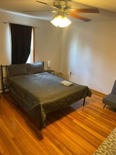 a bedroom with a bed and a ceiling fan at Homestay in Boston Pearl Street in Boston
