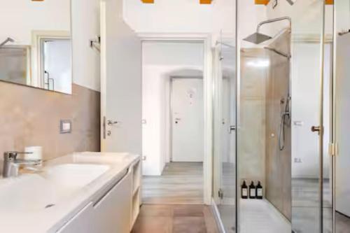a bathroom with two sinks and a shower at Luxury Lakeview Loft in Baveno