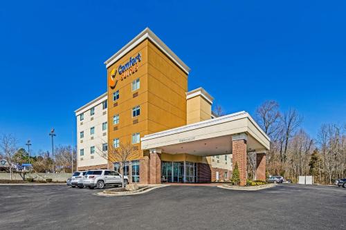 a hotel with a car parked in a parking lot at Comfort Suites Huntsville MidCity District at Research Park in Huntsville