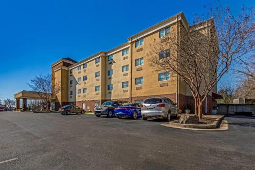a building with cars parked in a parking lot at Comfort Suites Huntsville MidCity District at Research Park in Huntsville
