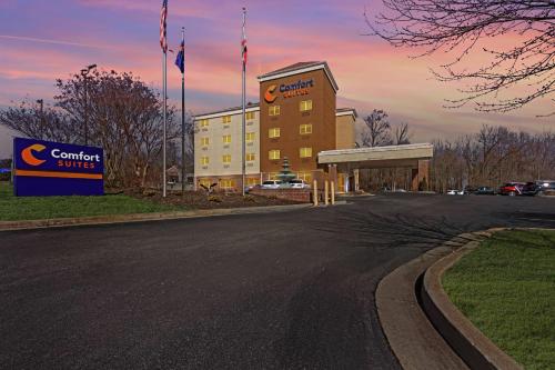 a building with a sign on the side of a road at Comfort Suites Huntsville MidCity District at Research Park in Huntsville