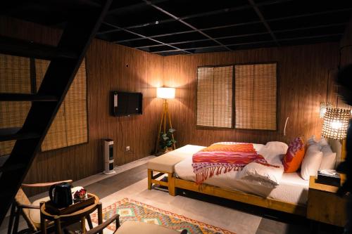 a bedroom with a bed in a room with wooden walls at Semari Resort in Muzaffarabad