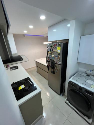 a kitchen with a refrigerator and a stove in it at El encanto de Cartagena in Cartagena de Indias