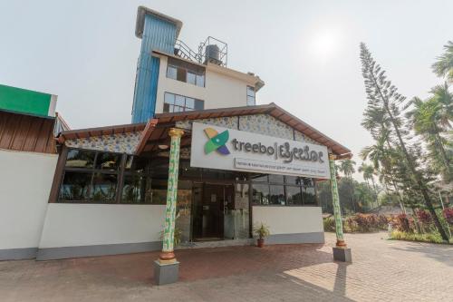 a building with a sign in front of it at Treebo Pratham Inn Water Park Resort With Swimming Pool in Kundapur