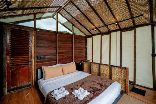 a bedroom with a bed in a room at Nirata Treehouse in Kintamani