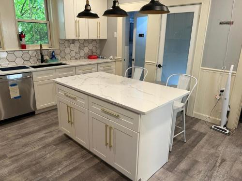 a kitchen with a large white island in a kitchen at HomeStay in Harvest Street in Boston