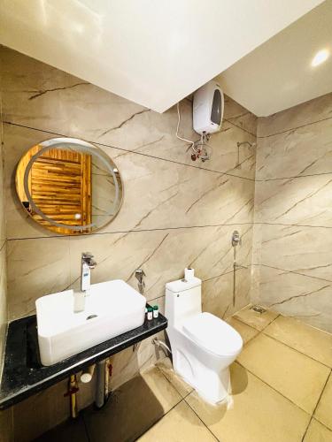 a bathroom with a sink and a toilet at Dhanrains La Rocha in Patnem