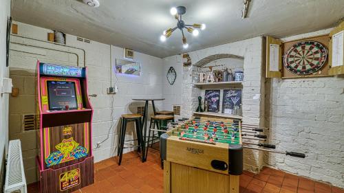a room with a video game machine and a table at Helter Skelter Matlock in Matlock