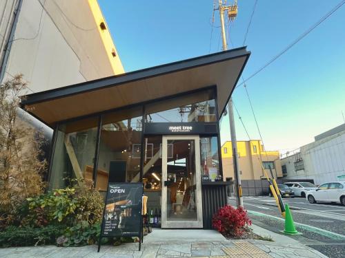 a building with a glass door on a city street at hatago STAY Shinmachi in Nakatsugawa