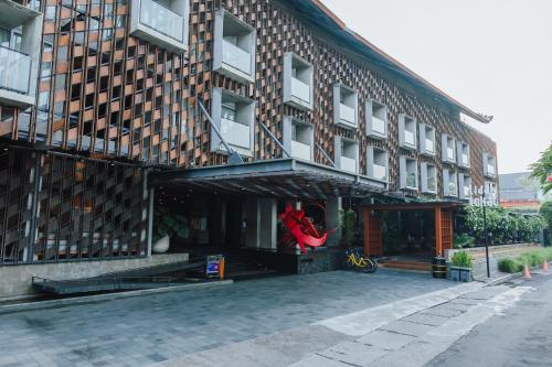 a building with a red hammock in front of it at ARTOTEL Sanur Bali in Sanur