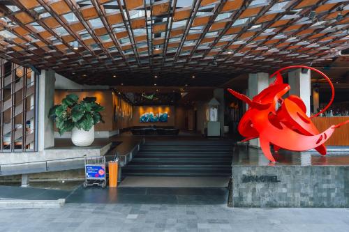 a red shark statue in front of a building at ARTOTEL Sanur Bali in Sanur