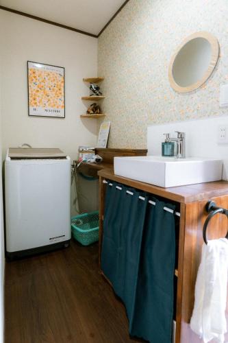 a bathroom with a sink and a mirror at sneaky peaks in Hakuba