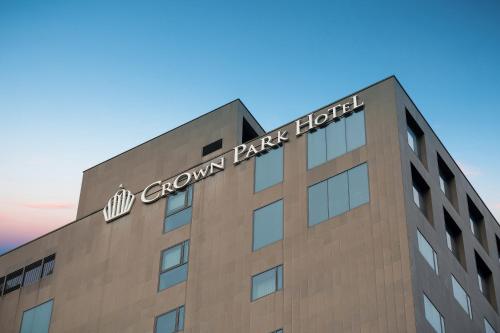 a building with a sign on the top of it at Crown Park Hotel Seoul Myeongdong in Seoul