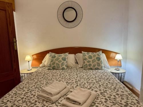 a bedroom with a large bed with towels on it at Casa Borguny - House in the centre of Palma in Palma de Mallorca