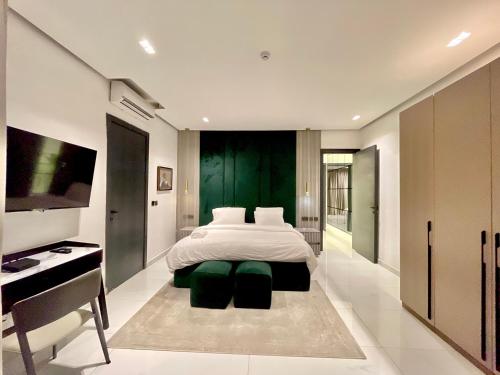 a bedroom with a bed and a desk and a television at 2 Bedroom in Lekki phase 1 in Mama