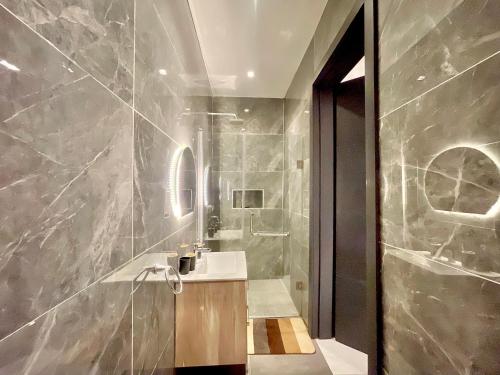 a bathroom with a sink and a shower at 2 Bedroom in Lekki phase 1 in Mama