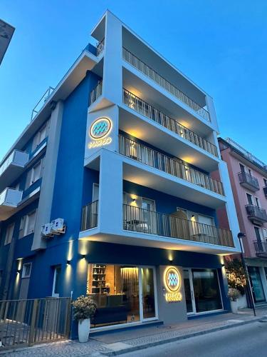 a blue building with a sign on the side of it at MAR60 Apartments in Caorle