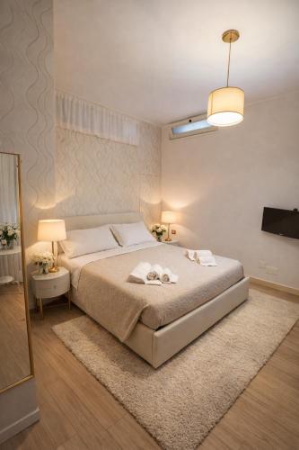 a bedroom with a bed with two towels on it at Enjoy Home Sorrento in Sorrento