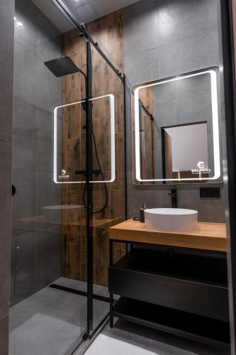 a bathroom with a sink and a mirror at Goldhill villa in Yaremche