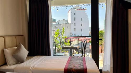 a bedroom with a bed and a window with a view at Hanoi Street Hotel in Hanoi