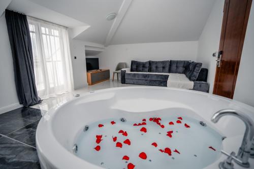 a bath tub with red fish on it in a living room at District&Villa De Lago in Ohrid
