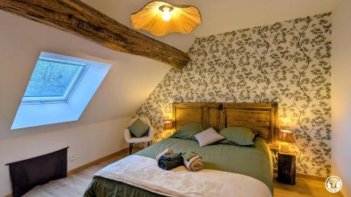 a bedroom with a bed and a window at Chez le Paul Jacques in Seigny