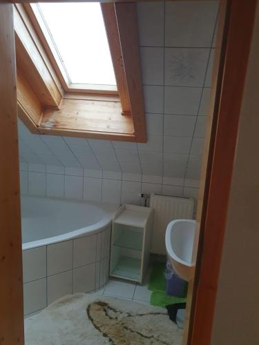 a bathroom with a tub and a sink and a window at Haus Pfatschbacher in Wildalpen