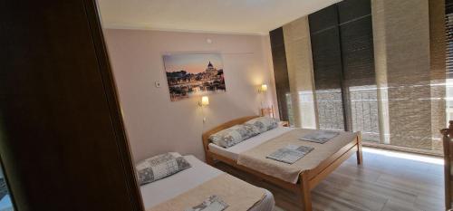 a small room with two beds and a window at Mimoza Apartments in Đenovići