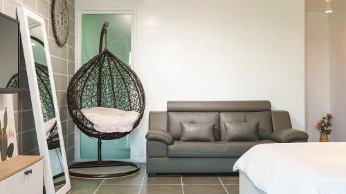 a living room with a couch and a swing at Namhae Briant Oceanview Spa Pension in Namhae