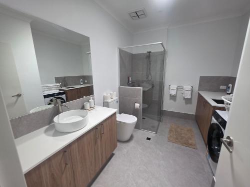 a bathroom with a sink and a toilet and a shower at Modern Private Townhouse Close to City & Transport in Perth