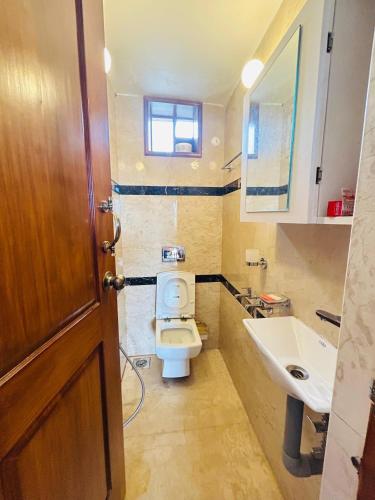 a bathroom with a toilet and a sink at Valley homes in Ooty