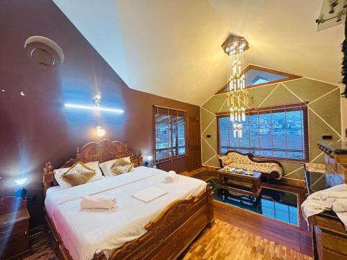 a large bedroom with a large bed and a desk at Valley homes in Ooty