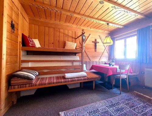 a room with a wooden cabin with a bench and a table at Almliesl THUR-746 in Lovara