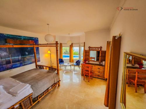 a bedroom with a bed and a desk and a table at Diamante Villa Mijas in Mijas