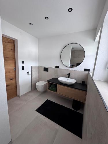 a bathroom with a sink and a mirror at Alpinelodge8 in Innsbruck