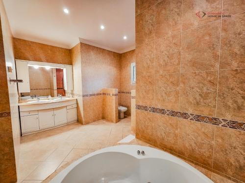 a large bathroom with a tub and a sink at Diamante Villa Mijas in Mijas