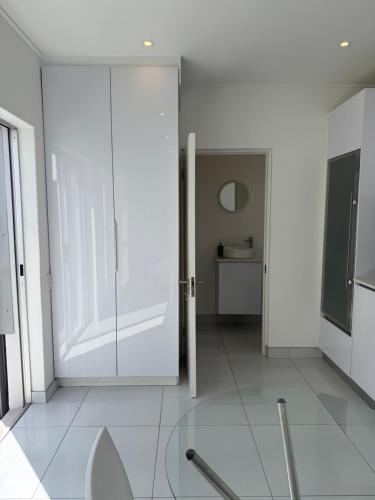 a white room with a sliding glass door at Studio on Main in Langebaan